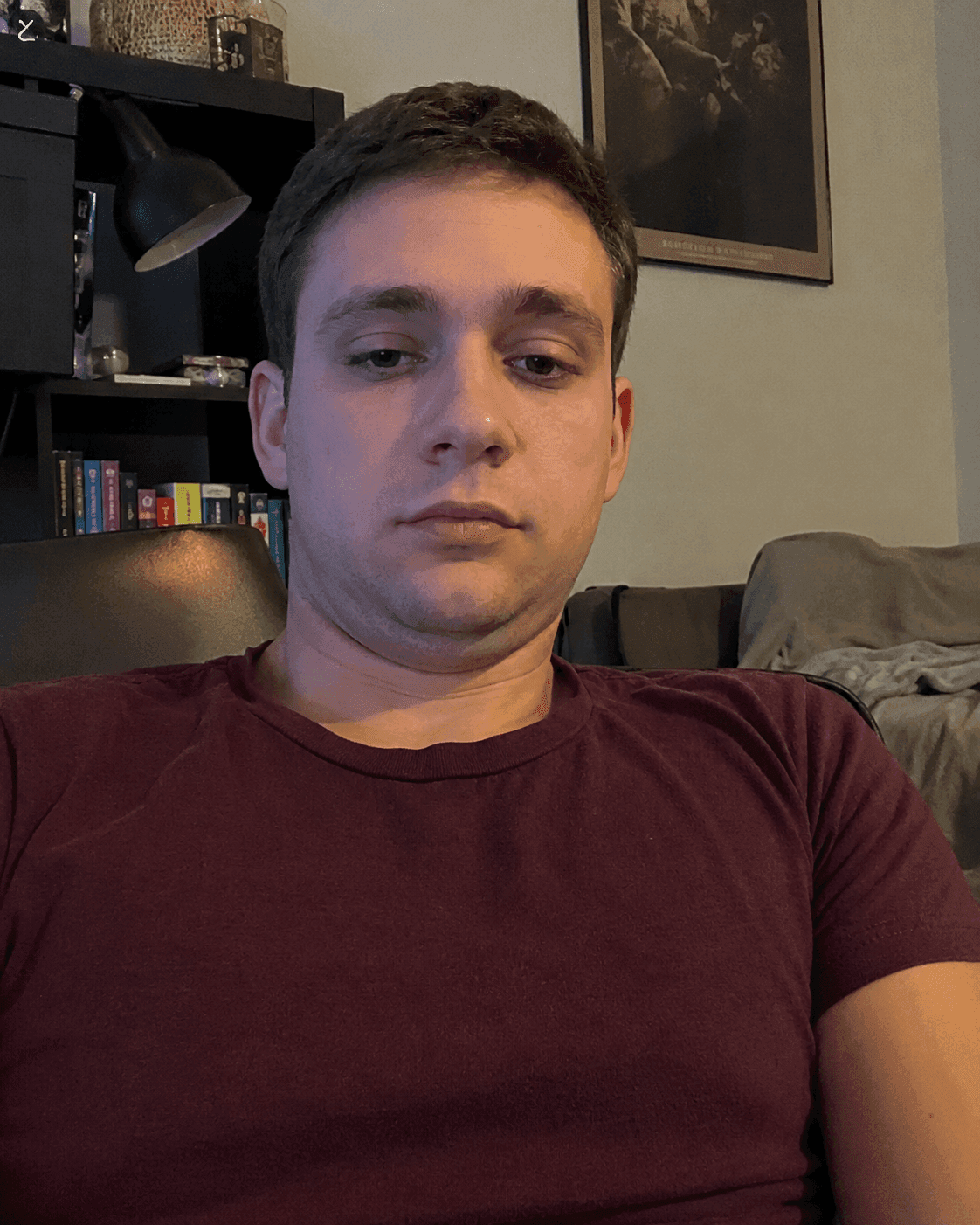Before photo: portrait of a male with a double chin sitting on his couch