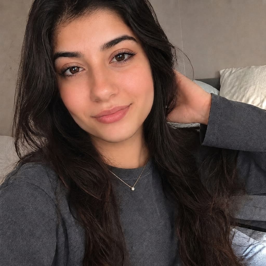 After jawline filter: dark-haired woman in a beauty pose selfie with a more defined, stronger jawline