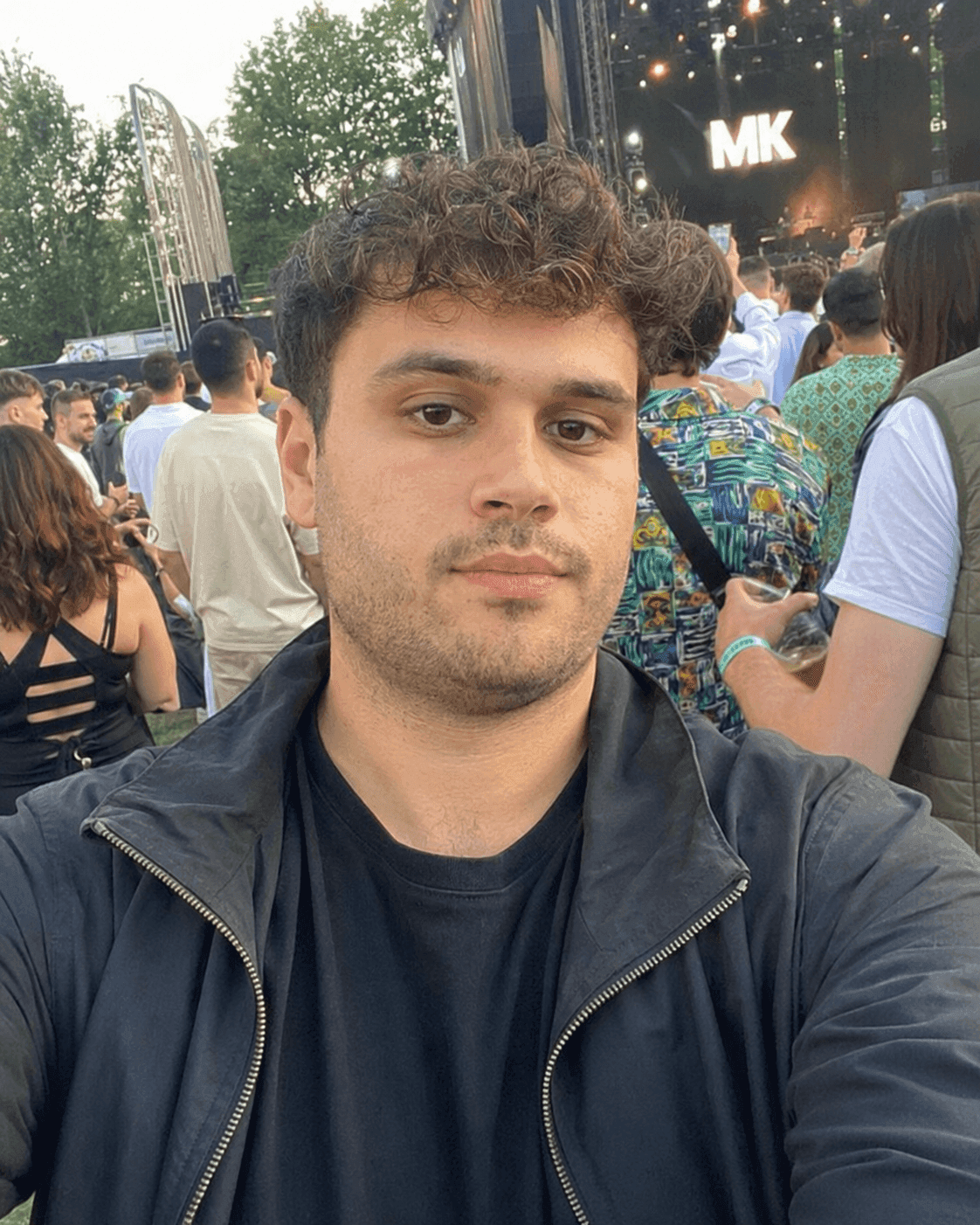 Before AI jawline editor: man's festival selfie with a softer jawline