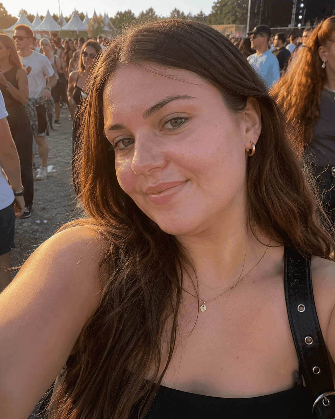Before AI jawline editor: woman's festival selfie with an undefined lower face