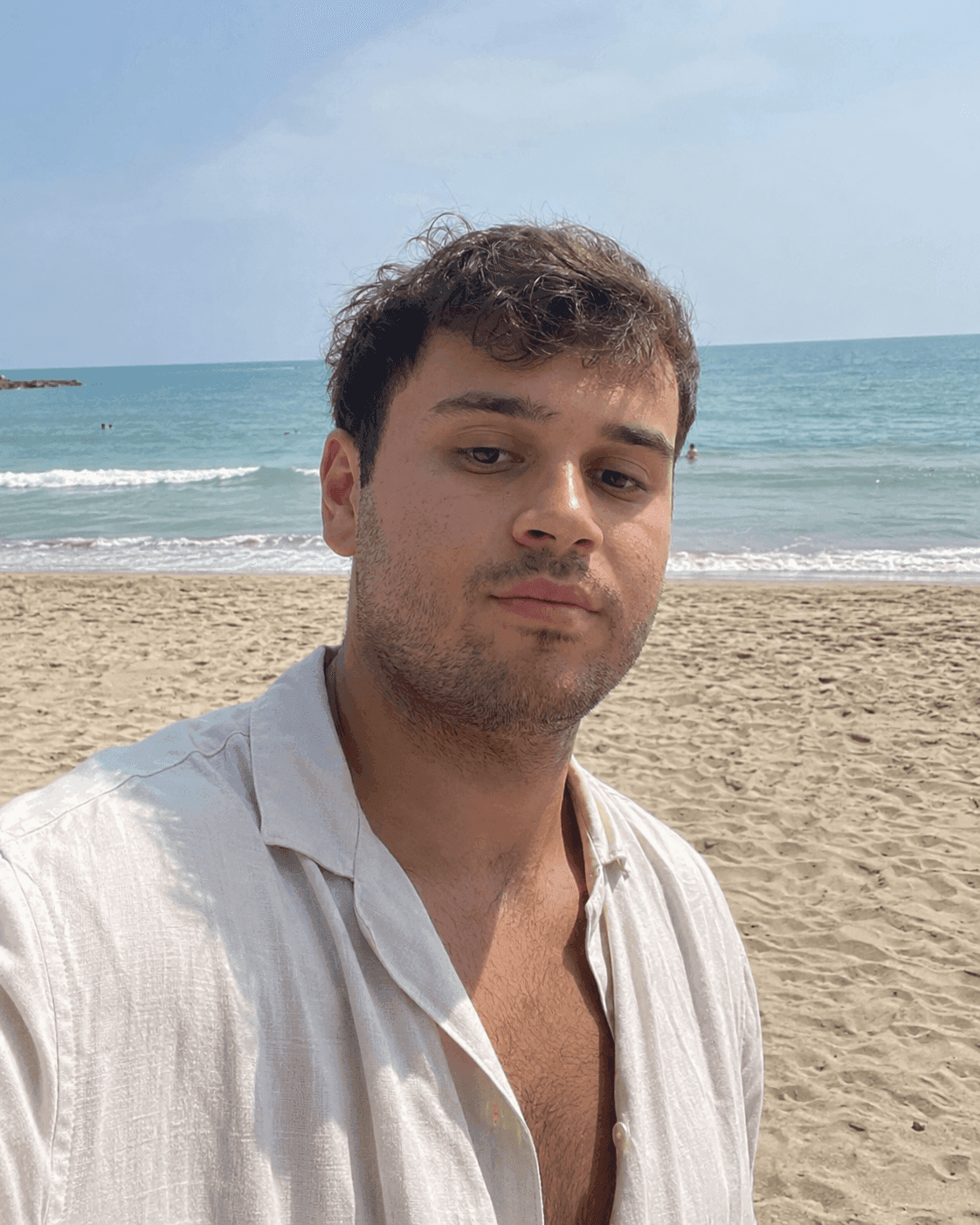 Before define jawline in photos: man's beach selfie with a soft, undefined jawline