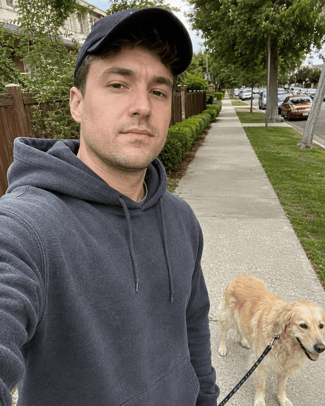 Before jawline enhancer: man's casual dog-walk selfie with a softer jawline